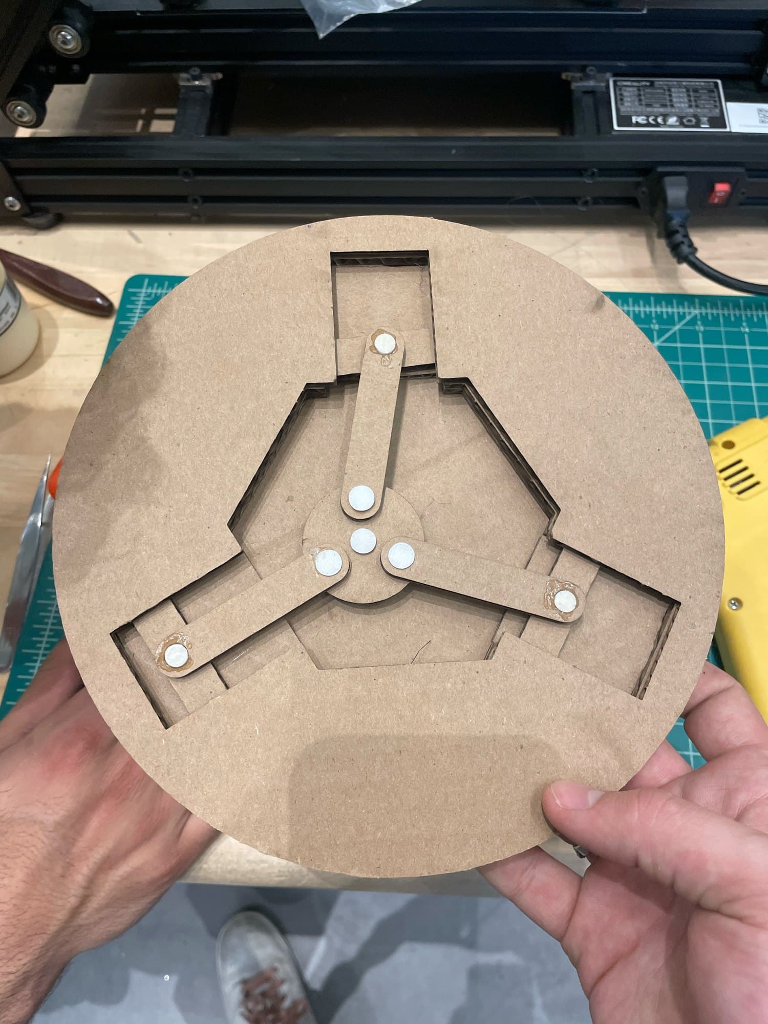 Figure 4: Laser-cut cardboard prototype used to prove the crank linkage before machining.